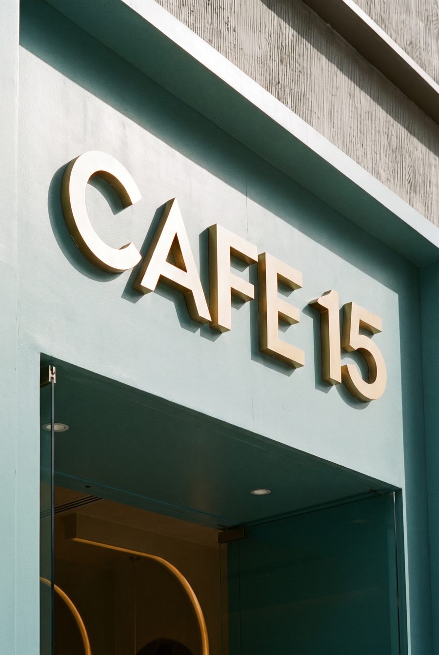 gold Cafe 15 lettering on the teal arch facade