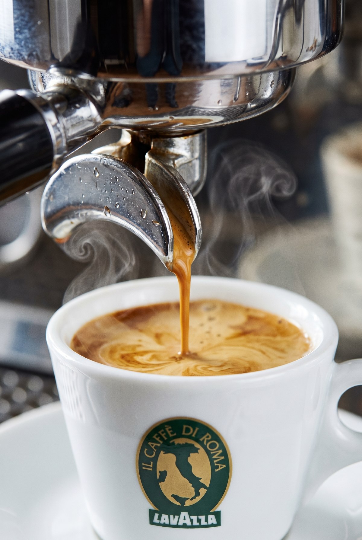 Espresso pouring into a branded cup
