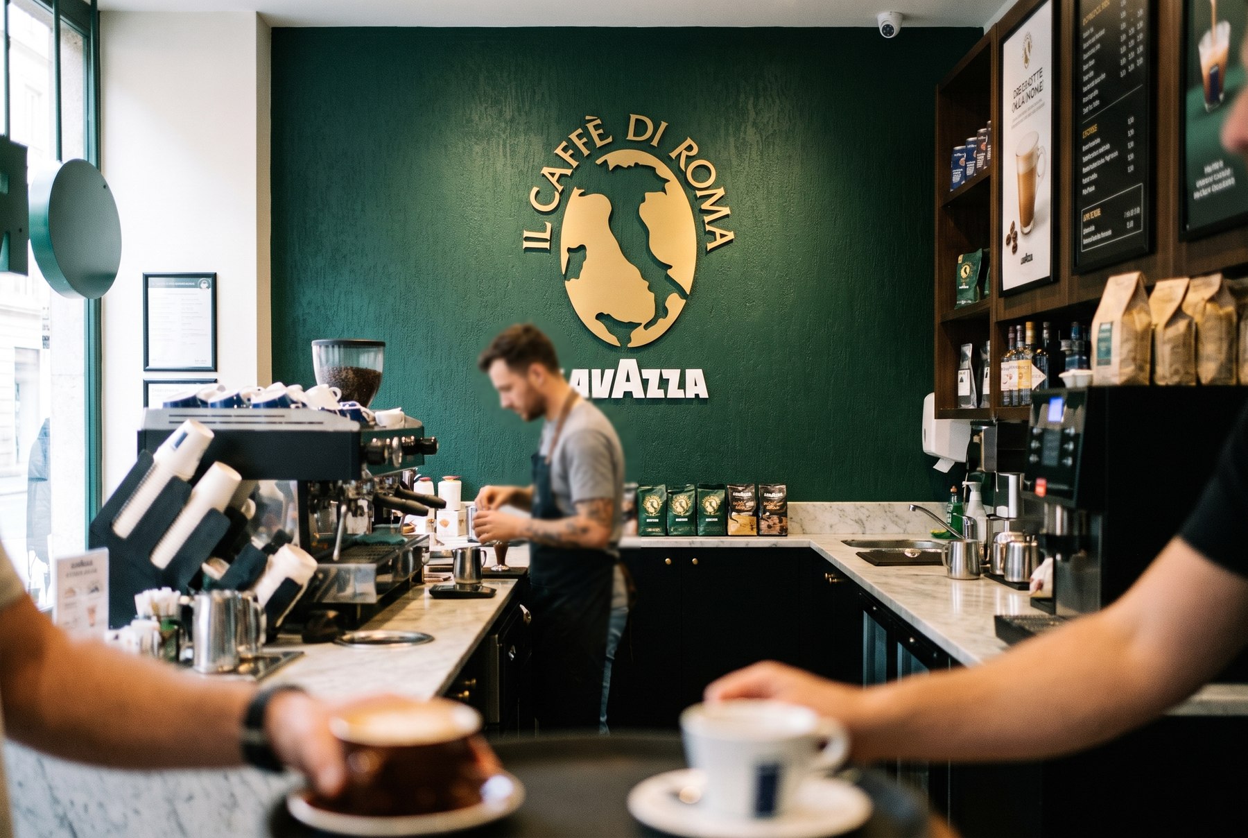 Inside an Il Caffe di Roma store, the gold emblem on the green wall