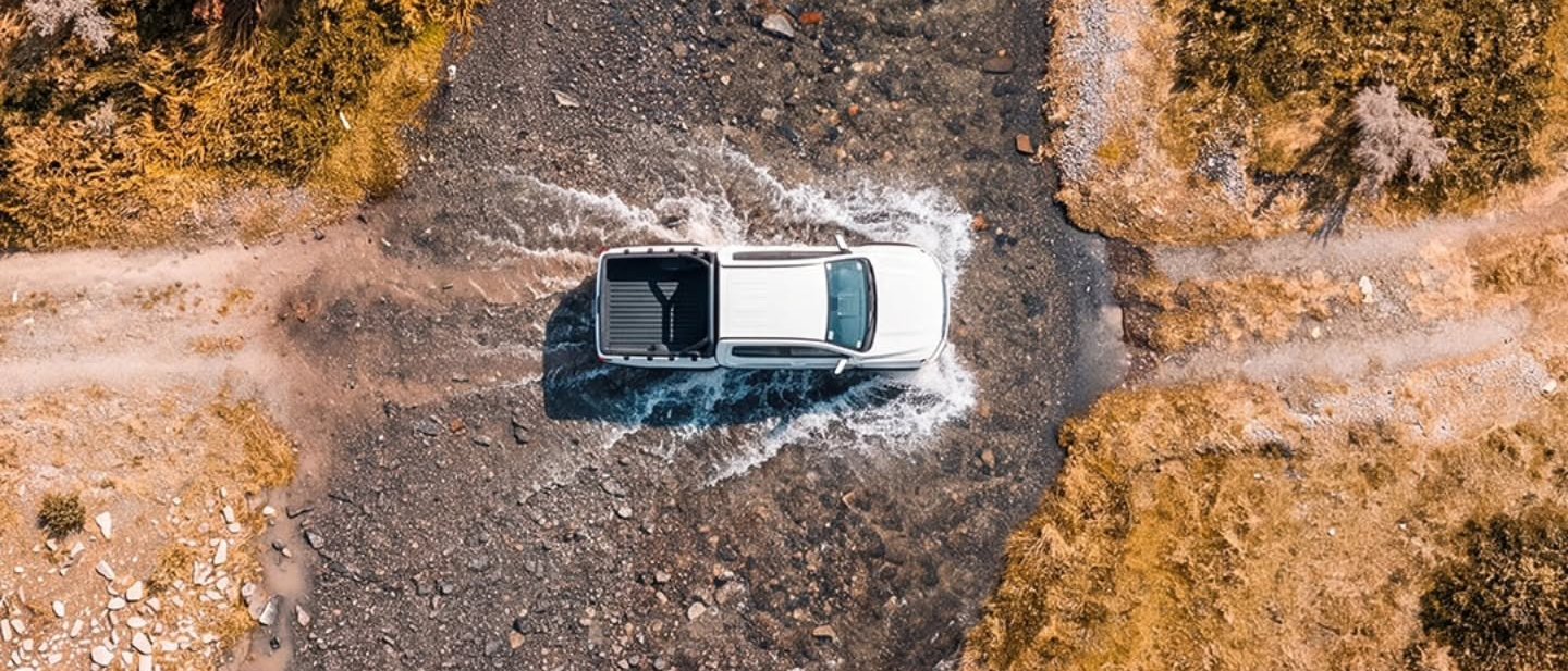 Aerial view of the Smilodon crossing a rocky wadi track
