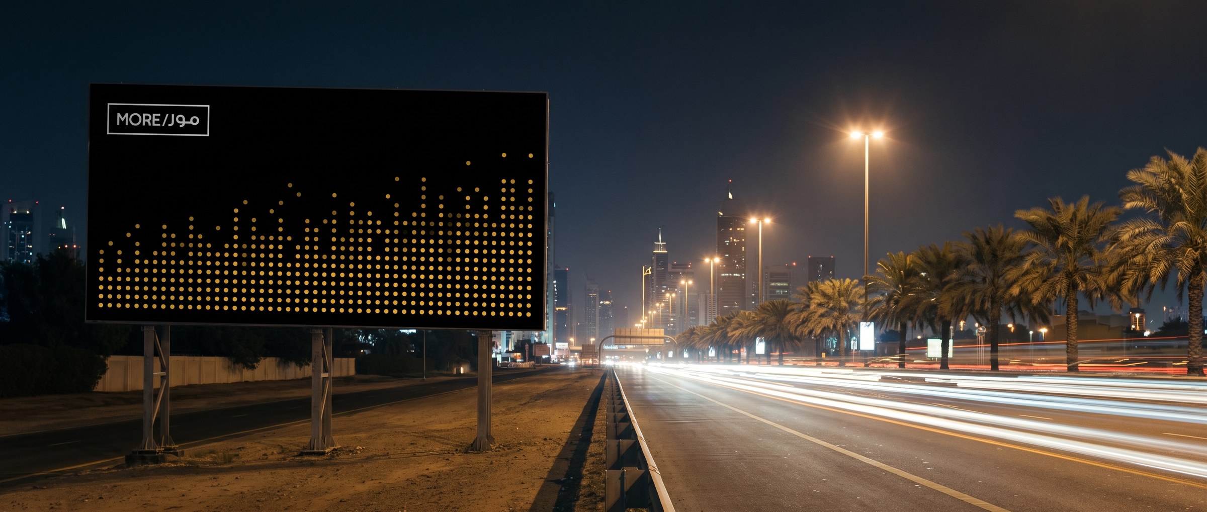 A roadside billboard carrying a rising field of yellow dots and the MORE mark