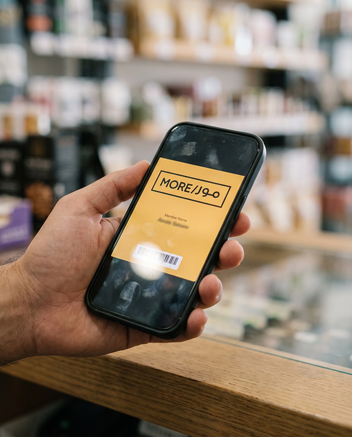 The MORE wallet pass open on a phone in store